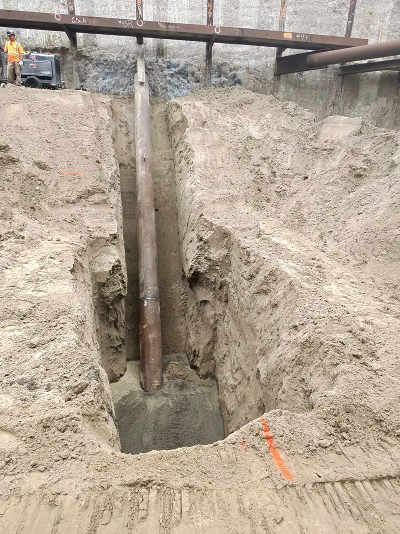 Installed diagonal pipe raker bracing an excavation support wall