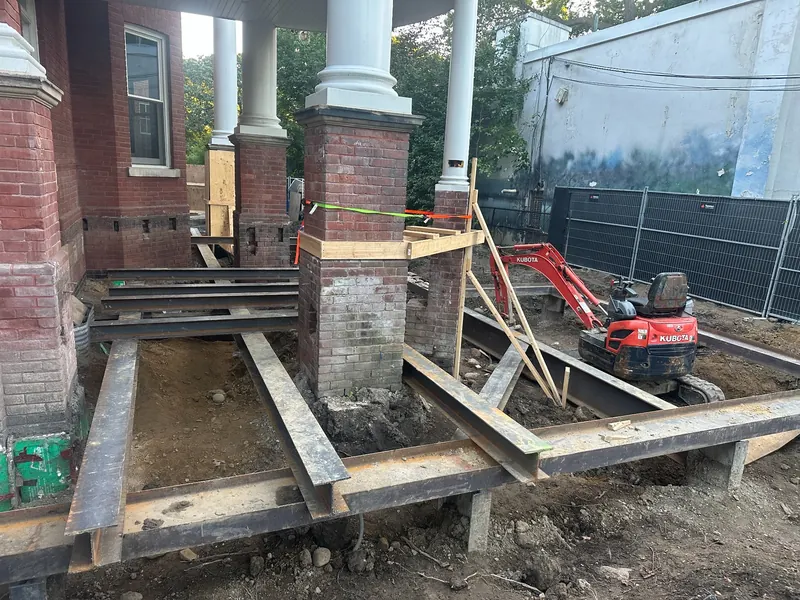 Residential shoring with temporary steel support near existing brick columns