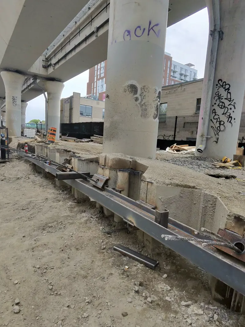 Steel face waler attached along a sheet pile retaining wall